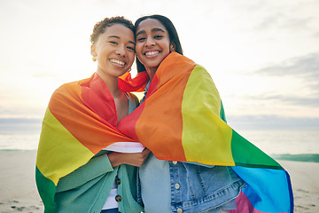 Image showing Rainbow flag, gay couple or women with love outdoor for happiness, rights and pride at sunset. Portrait of LGBTQ or lesbian friends or people in at beach for freedom, date and hug with happy partner