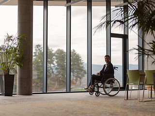 Image showing Businessman in a wheelchair in a modern office lonely after a busy day