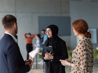 Image showing A group of young business entrepreneurs engages in a lively discussion within the office, exemplifying the spirit of teamwork, innovation, and ambition in pursuit of success.