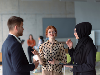 Image showing A group of young business entrepreneurs engages in a lively discussion within the office, exemplifying the spirit of teamwork, innovation, and ambition in pursuit of success.