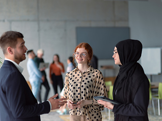 Image showing A group of young business entrepreneurs engages in a lively discussion within the office, exemplifying the spirit of teamwork, innovation, and ambition in pursuit of success.