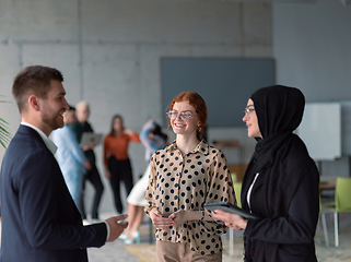 Image showing A group of young business entrepreneurs engages in a lively discussion within the office, exemplifying the spirit of teamwork, innovation, and ambition in pursuit of success.