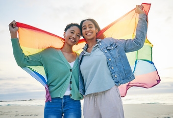 Image showing Woman, lesbian couple and pride flag on beach together in happiness for LGBTQ community or rights. Portrait of proud and confident gay or bisexual women smile on ocean coast in love, support or trust