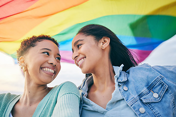 Image showing Lesbian women, couple and outdoor with pride flag, smile or wind with wave, lgbtq inclusion and equality. African girl, fabric or cloth for human rights, sexuality and happy with rainbow on vacation