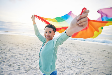 Image showing Woman, beach and rainbow pride flag in portrait with smile, wind and waves for lgbtq, inclusion and equality. African girl, fabric or cloth for human rights, lesbian sexuality and happy on vacation