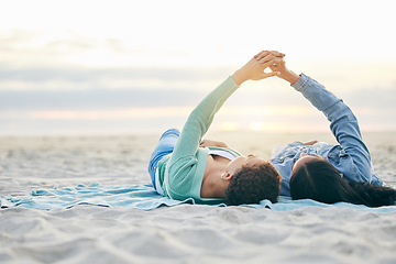 Image showing Love, beach and lesbian couple on blanket together, holding hands on sand and sunset holiday adventure. Lgbt women, bonding and relax on ocean vacation with romance, pride and happy lying in nature.