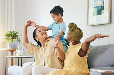 Image showing Gay family, lesbian couple and boy child on a sofa with airplane, game and fun in their home together. Love, lgbt and women mother in a living room with kid and piggyback, bond and playing in a house