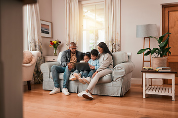 Image showing Laptop, sofa and family watching a movie online together in the living room of their home. Relax, technology and cute children streaming film, show or video on a computer with their parents in house.