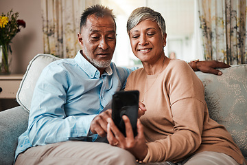 Image showing Senior couple, phone and reading on home sofa with internet connection, network and love. Mature man and woman relax together on a couch with smartphone for streaming and online news or social media