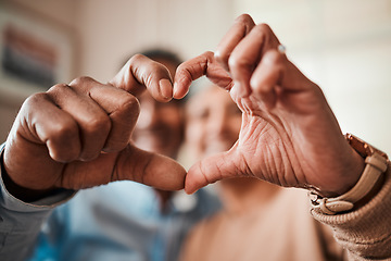 Image showing Senior couple, heart shape and hands at home with love, happiness and care. Man and woman relax together with icon, symbol or emoji for commitment, marriage and trust or support on valentines day