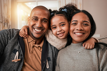 Image showing Happy, smile and portrait of a family in the living room hugging with love, care and comfort at home. Happiness, excited and girl child holding her mother and father in the lounge of their house.