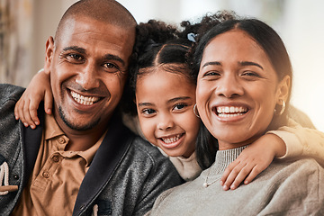 Image showing Happy, hug and portrait of a child with her parents in the living room of their family home. Happiness, smile and sweet girl kid holding her mother and father in the lounge of her modern house.