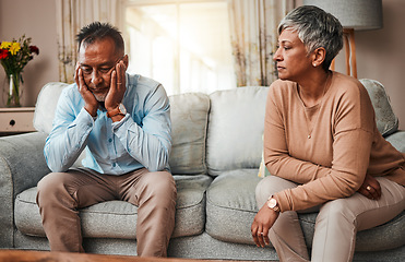 Image showing Angry, senior couple and fight on sofa, divorce and conflict with a breakup, depression and stress. Sad, old woman and elderly man with mental health, cheating and separation with crisis at home