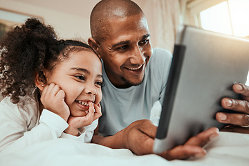 Image showing Father watching a movie on a tablet with his child in bed to relax, rest and bond together. Happy, smile and young dad streaming show or video on social media on digital technology with kid at home.