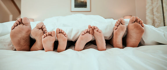 Image showing Sleeping, feet and family in bed relax, peaceful and enjoying. a nap in their home together. Foot, sleep and children resting with in parents in a bedroom with love, safety and or vacation freedom