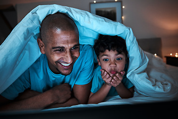 Image showing Night, streaming and father with child in a bed for movie, file or subscription entertainment in their home. Television, watching and parent with boy kid in a bedroom bond, happy and having fun