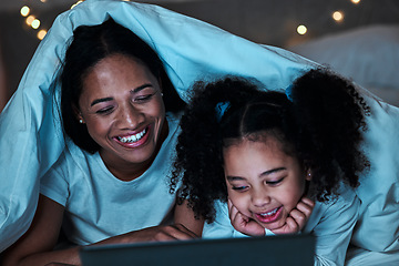 Image showing Mom, child and tablet with blanket in bedroom at night to play games, social media and reading ebook. Happy mother, girl and kid relax with digital technology, watching cartoon or movies in dark fort