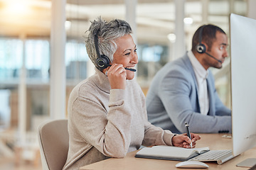 Image showing Computer, smile and an elderly woman in a call center for customer service, support or assistance online. Contact, headset and a happy senior consultant working at a desk in a professional crm office