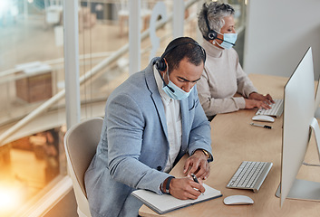 Image showing Face mask, call centre and customer service people with computer and writing notes or information. A man and woman telemarketing consultant with ppe for networking, help desk or sales account details