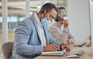 Image showing Call center, face mask and writing with business man in office for communication, consulting or advice. Healthcare, virus and bacteria with employee in agency for communication, help desk and hygiene