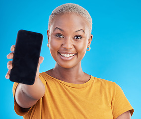 Image showing Woman, portrait and phone screen, mockup or social media marketing with Web 3.0 ui or ux design space in studio. African person with mobile for information, presentation or contact on blue background