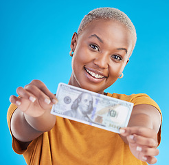 Image showing Black woman, dollar and finance, portrait and happy with prize, loan and cash on blue background. Money, cashback and lottery win with payment, financial freedom and note with bonus in studio