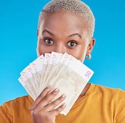 Image showing Cash, winner and woman cover face on blue, studio background for winning, money fan or financial loan. Lottery, bank and young african person with bonus, budget secret and finance profit in portrait
