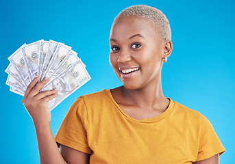 Image showing Black woman, cash fan and finance, portrait and happy with prize, loan and dollars isolated on blue background. Money, cashback and lottery win with payment, financial freedom and bills in studio