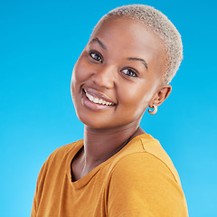 Image showing Black woman, portrait and happy, smile in a studio with youth and positive mindset isolated on blue background. Casual fashion, headshot and African female person, face and t shirt with happiness