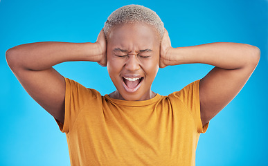 Image showing Headache, hands on ears and black woman shout in studio isolated on a blue background. Stress, noise and African person frustrated with loud sound, pain or crisis of tinnitus, not hearing or listen