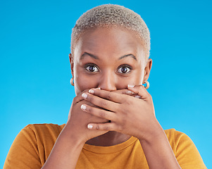 Image showing Gossip, secret or portrait black woman shocked by mistake or announcement in studio on blue background. Wow, fake news or surprised girl with excited, wtf or omg expression with hands to cover mouth