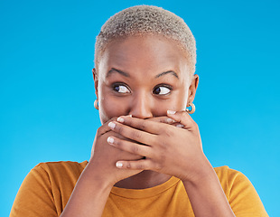 Image showing Gossip, wow or black woman shocked by secret, mistake or announcement in studio on blue background. Thinking, fake news or surprised girl with excited, wtf or omg expression with hands to cover mouth