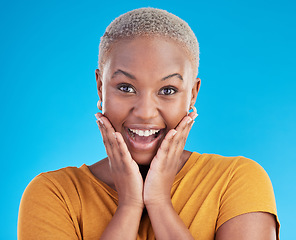 Image showing Surprise, portrait and excited black woman in studio for shocking news or deal offer on blue background. Wow reaction, omg and happy female person shocked by gossip, announcement, promotion or deal