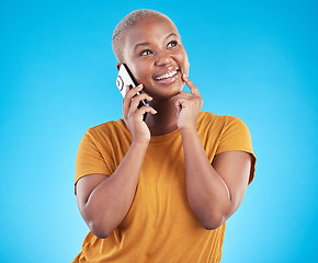 Image showing Happy woman, phone call and thinking of university decision, listening to news and feedback on a blue, studio background. African person or student on mobile communication, ideas and future planning