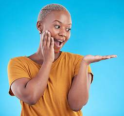 Image showing Wow, mockup and promotion from a black woman on a blue background for marketing or a product. Sale, customer and an African girl or promoter with surprise and space for advertising or announcement
