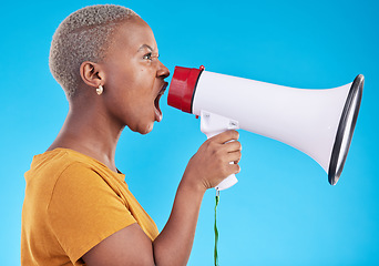 Image showing Black woman, megaphone and shout in studio, protest and profile with noise for human rights by blue background. African gen z student, girl and audio tech for justice, opinion or news announcement