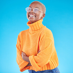 Image showing Thinking, happy and black woman with glasses, arms crossed and studio isolated on a blue background. Excited, confident nerd and African geek smile for fashion, style and person in casual clothes