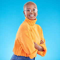 Image showing Portrait, happy and black woman with glasses, arms crossed and studio isolated on a blue background. Face, confident nerd and smile for fashion, style and person from South Africa in casual clothes