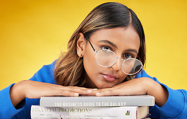 Image showing Woman, student and books in studio portrait with glasses, financial education and commitment by yellow background. Gen z girl, learning and studying economy with mindset, knowledge and development