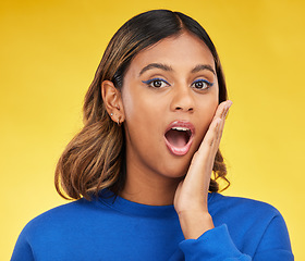 Image showing Shock, surprise and portrait of woman in a studio with a puzzled or wtf facial expression. Young, good news and young Indian female model with a wow or omg face isolated by a yellow background.