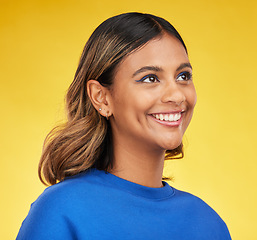Image showing Thinking, smile and skincare with a woman on a yellow background in studio for fashion or cosmetics. Face, idea and a happy young female model posing indoor in a trendy outfit for clothes style