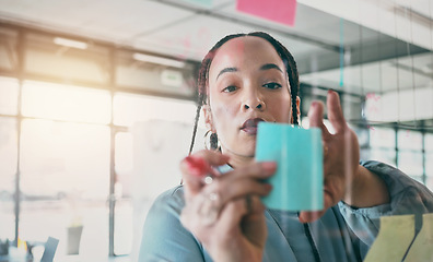 Image showing Woman at glass with ideas, moodboard and sticky note for business planning, brainstorming or working process. Thinking, strategy and writing notes for startup proposal on mind map at office workshop.