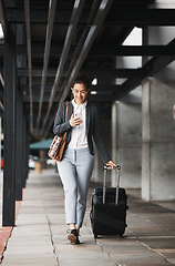 Image showing Phone, travel and suitcase with a business woman walking in an airport parking lot outdoor in the city. Mobile, luggage and commute with a young female employee on an international trip for work