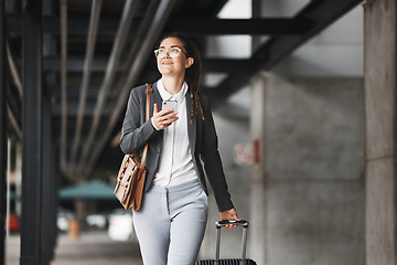 Image showing Phone, vision and luggage with a business woman walking in an airport parking lot outdoor in the city. Mobile, suitcase and travel with a young female professional on an international trip for work