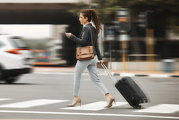 Image showing Business travel, phone and woman with luggage in city street for location, search or texting. Smartphone, app and blur with suitcase in New York online for fast transport, taxi or service request