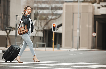 Image showing Business, travel and phone call by woman with luggage in city street for networking or work trip. Smartphone, conversation and lady on road crosswalk with suitcase for traveling appointment in London