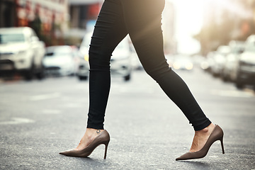 Image showing High heels, business and woman crossing the street closeup in a city on her commute to work. Feet, fashion and a female employee walking on an asphalt road in an urban town for a professional career