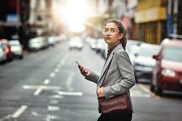 Image showing Phone, portrait of woman and cross street for journey, sunset commute and social media on internet. Mobile, consultant and person walk in city on smartphone for business, cbd travel and lens flare