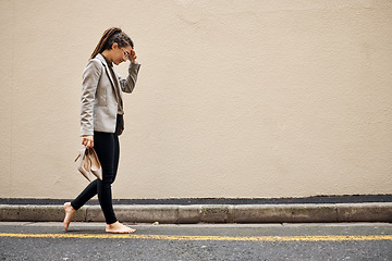 Image showing Tired, sad and business woman in city for thinking, fatigue and headache. Burnout, mental health and mistake with female employee walking in street for depression, failure and crisis with wall mockup