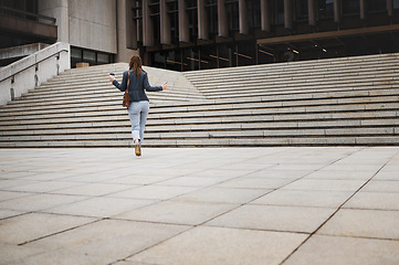 Image showing Walking, travel and business woman in city with ambition for morning commute, journey and building. Professional, growth and back of female person by steps for career progress, work and job in town